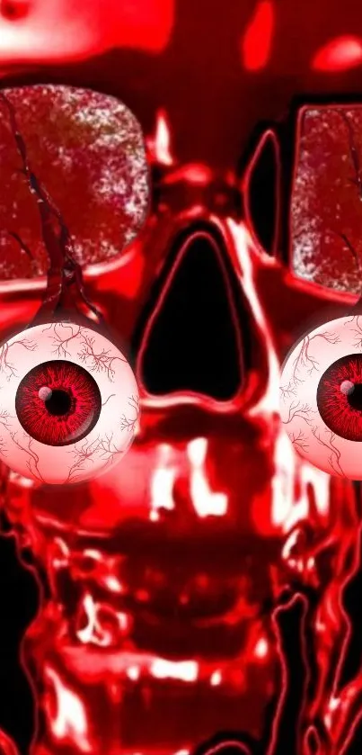 Red skull wallpaper with eyeballs and a bold, eerie design for mobile devices.