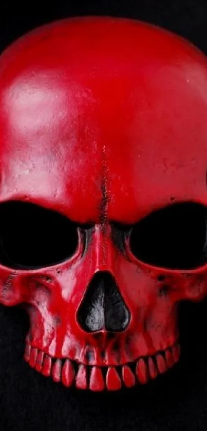 Red skull on a dark black background for mobile wallpaper.