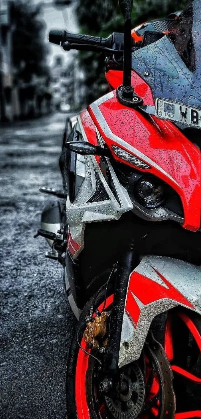 Red sports bike parked on a rainy street, showcasing sleek design and vibrant color.