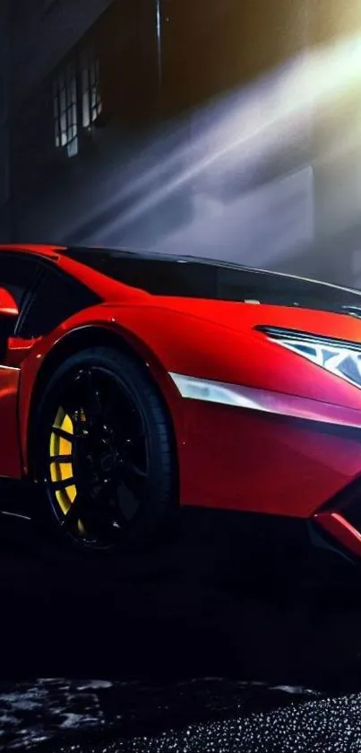 Red sports car illuminated in a dark, urban night setting.