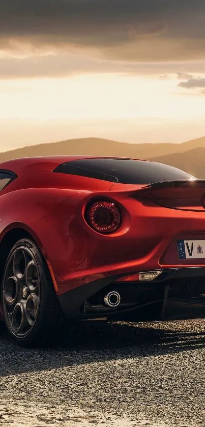 Stunning red sports car with sunset backdrop.