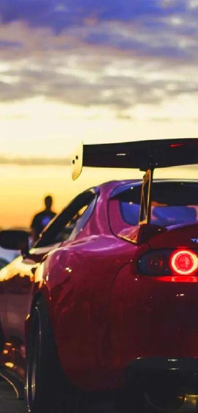 Red sports car with glowing lights at sunset.