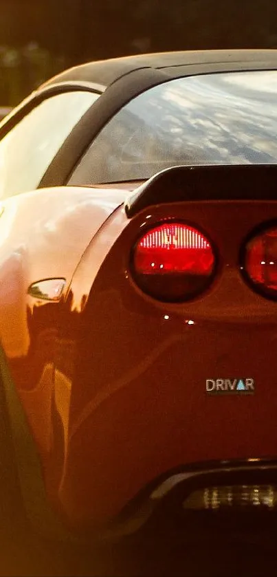 Red sports car driving at sunrise on a highway, showcasing speed and adventure.