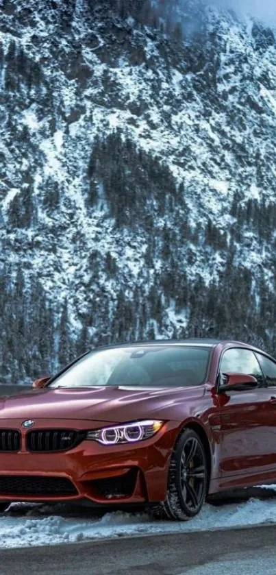 Red sports car in snowy mountain scenery