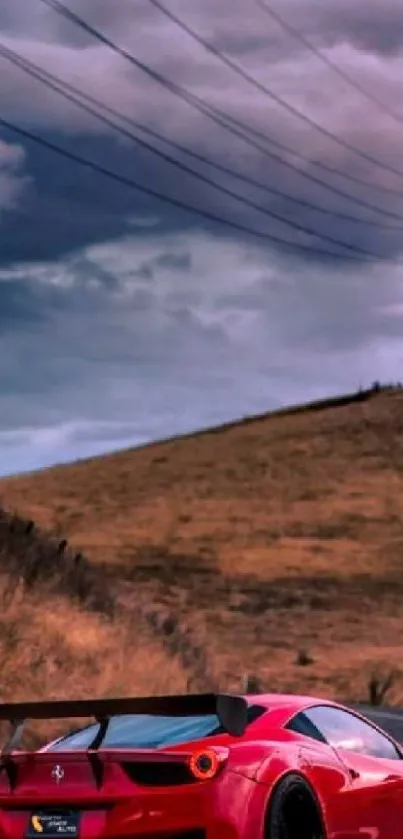 Red sports car on a winding road with dramatic sky background.