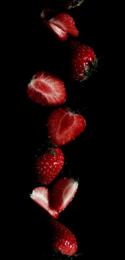 Red strawberries on a black background wallpaper.