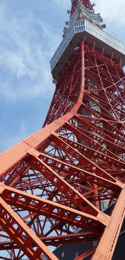 Red steel tower against blue sky background.