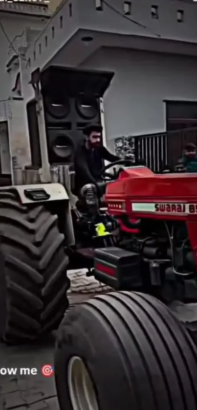 Red tractor driving through a modern urban environment.