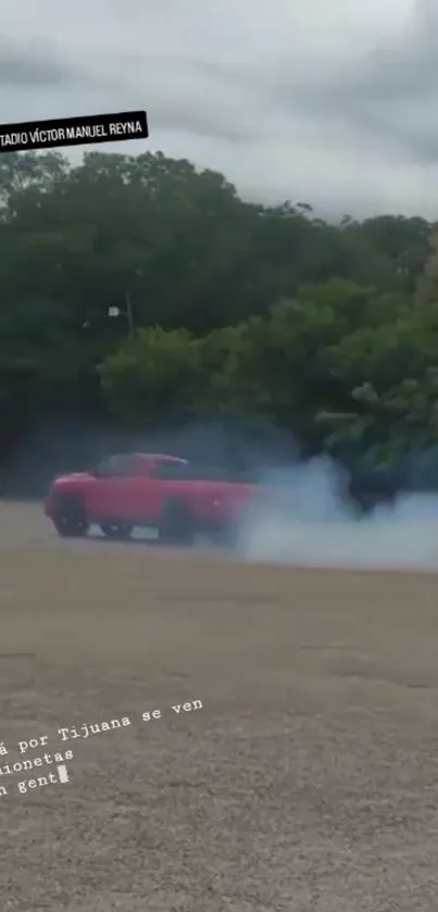 Red truck drifting on a smoky countryside road.