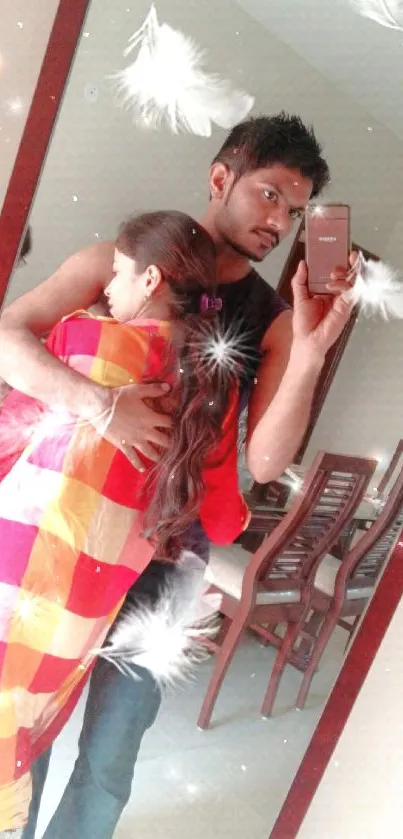 Romantic couple hugging in mirror with floating feathers in background.