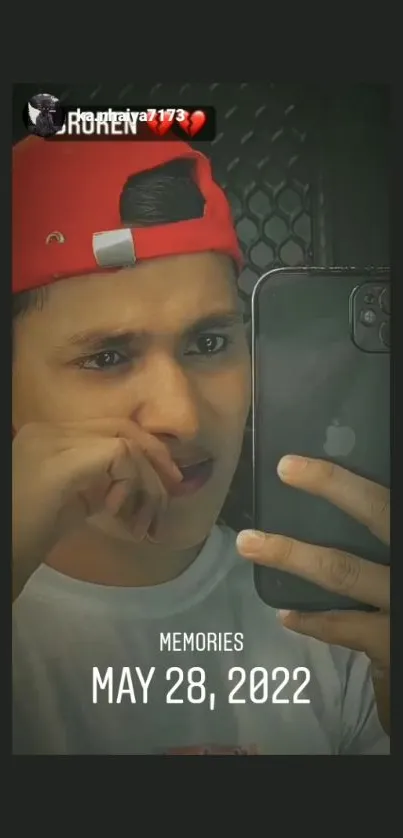 Mobile wallpaper showing a young man taking a selfie, emphasizing reflection and memories.