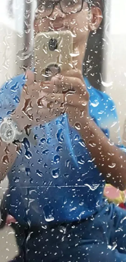 Reflective raindrop wallpaper with a person holding a phone.