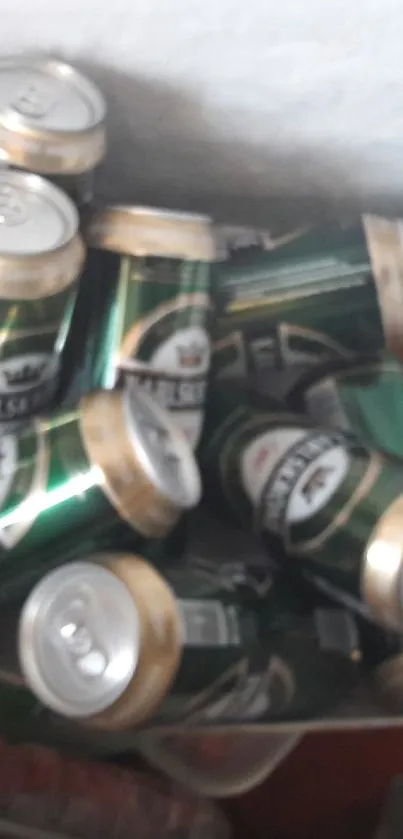 Dark green beverage cans stacked in an ice bucket.