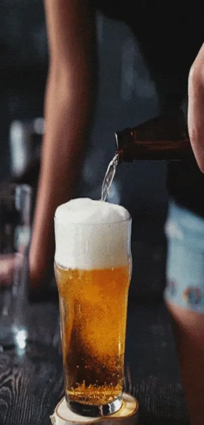 Pouring beer into a glass with a frothy foam head.