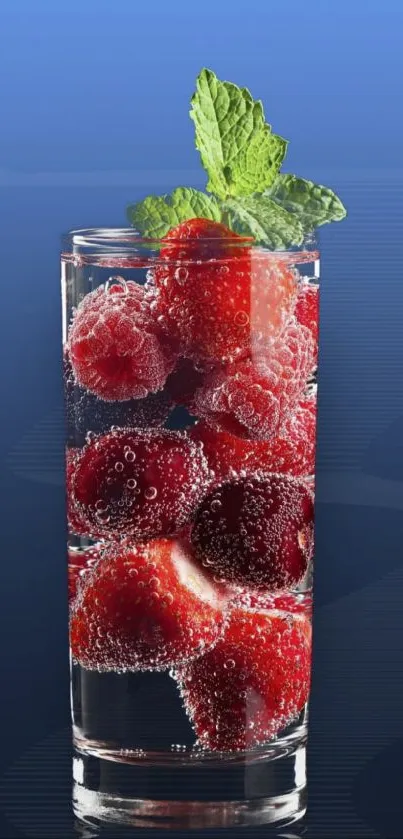 Glass with berries and mint in water on a blue background wallpaper.