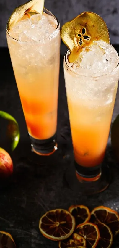 Two tall glasses of citrus cocktails with fruit slices.