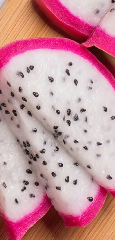 Dragon fruit slices and pink drink on wooden board.