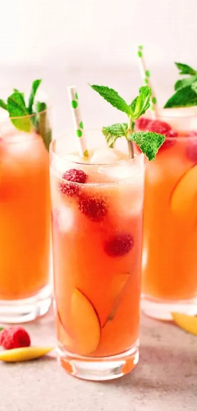 Refreshing peach and berry drink with mint garnish in a vibrant setting.