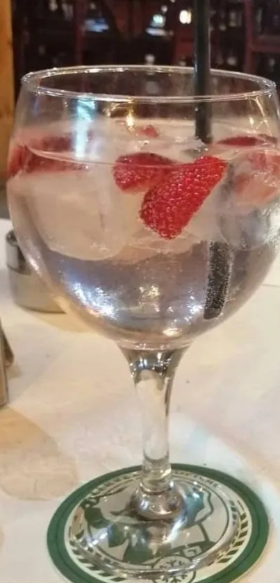 Stylish glass with strawberry cocktail on table.