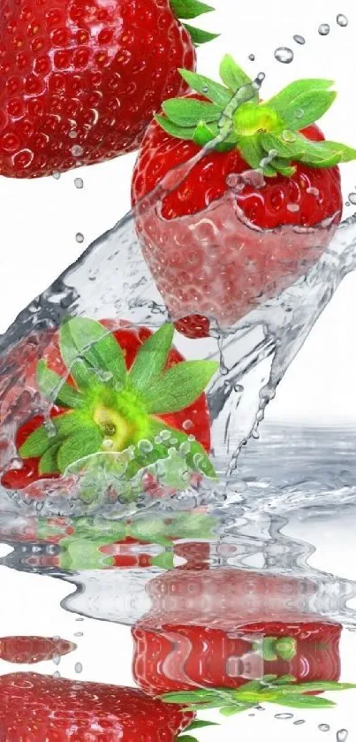 Strawberries splashing in clear water with a mirrored reflection.