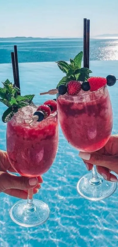 Two fruity cocktails by a sunny poolside, perfect for summer.