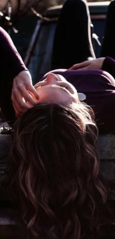 Woman relaxing on car, autumn setting.