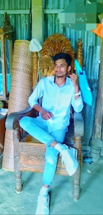 Man sitting casually in a wooden chair.