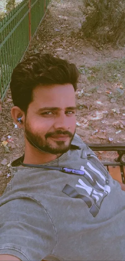 Man relaxing on a park bench with earphones.