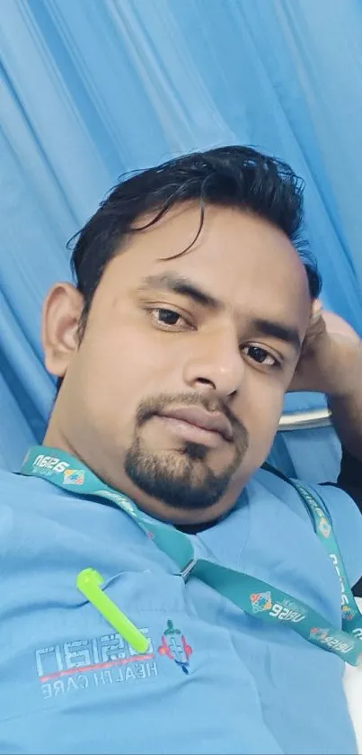 Relaxed person in blue medical uniform lying calmly.