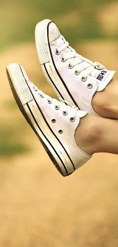 Relaxed legs in sneakers hanging from a car window on a sunny road trip.