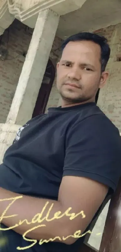 Portrait of a man sitting outside, exuding a relaxed summer vibe.