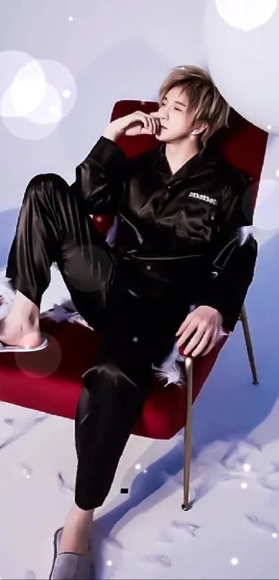 A person in black clothing relaxes on a red chair against a pastel background.