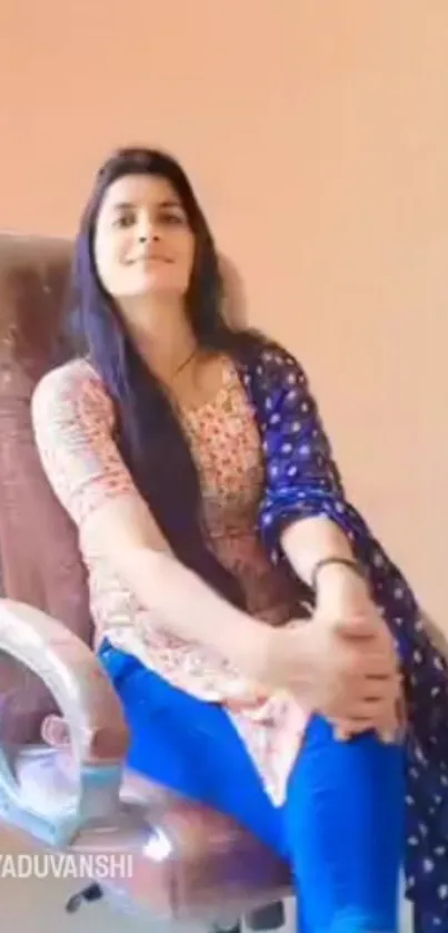 Young woman sitting on a chair indoors.