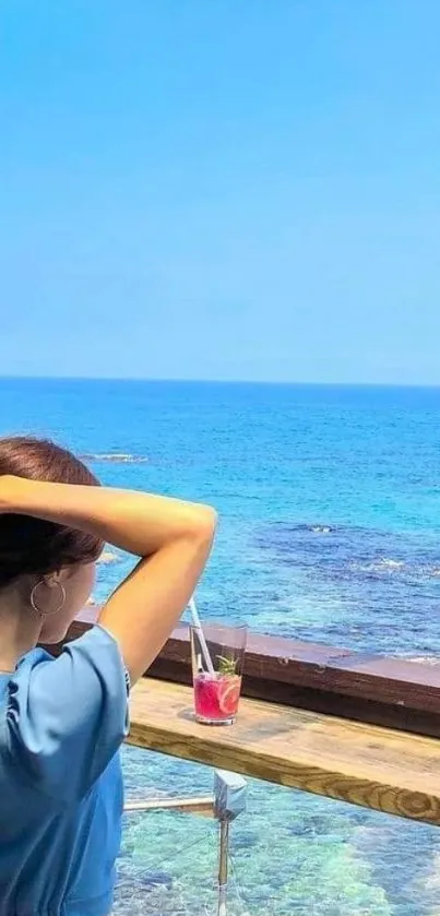 Woman enjoying a serene ocean view from a beachside cafe, perfect for relaxation.