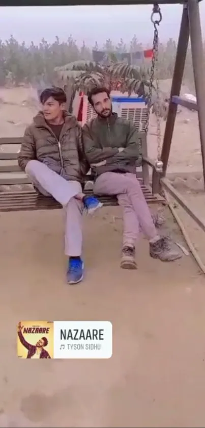 Two people sitting on a wooden swing in a peaceful outdoor setting.