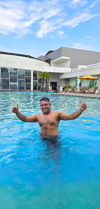 Man enjoying a swim in a clear blue pool on a sunny day.