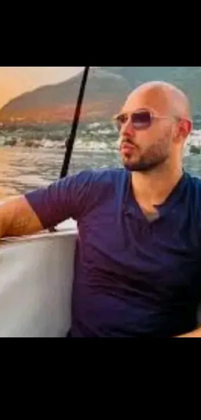 Man relaxing on a boat during sunset with scenic orange sky.