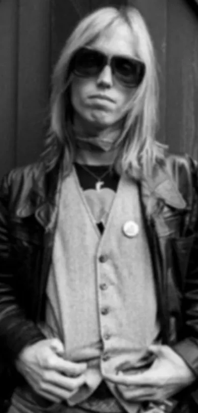 Black and white portrait of a man in leather jacket and sunglasses.