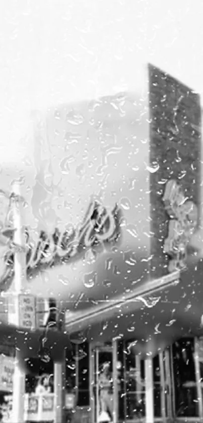 Monochrome city building with raindrops on glass.