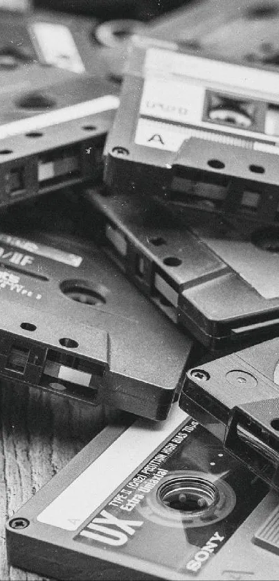 Pile of vintage cassette tapes in black and white.