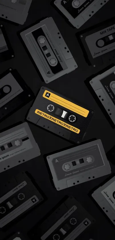 Retro cassette tapes in black and yellow on a mobile wallpaper.