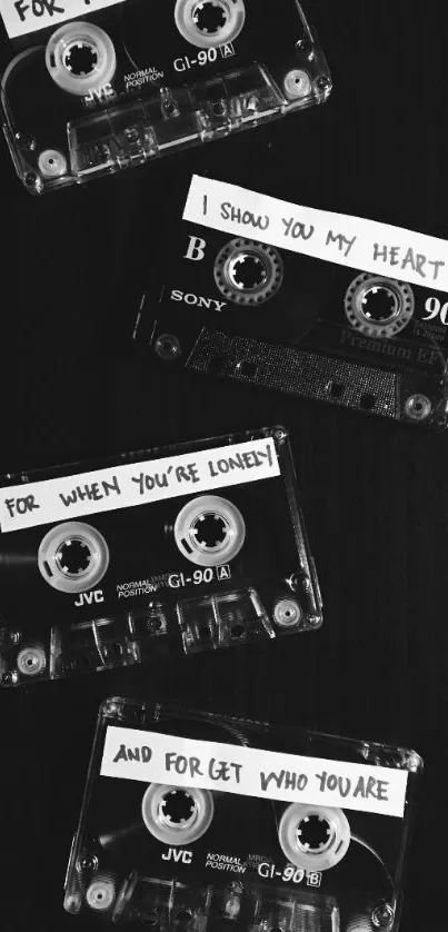 Vintage cassette tapes on black background with handwritten labels.