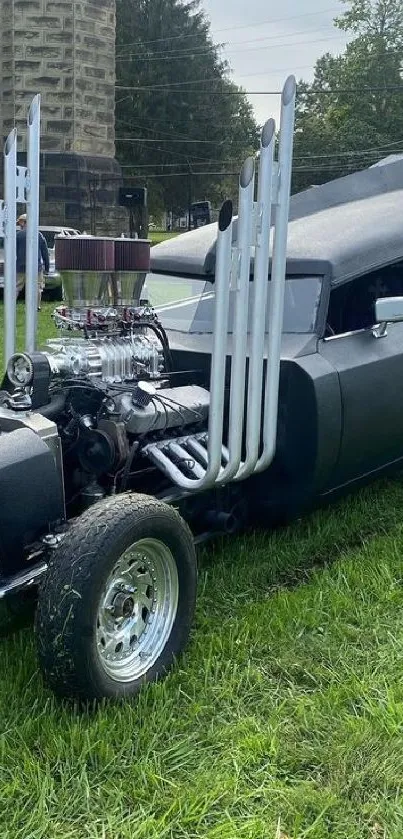 A retro custom car on a green lawn, showcasing vintage charm and style.