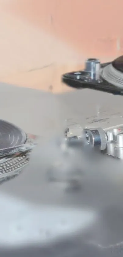 Close-up of a DJ turntable set with gray and beige tones.