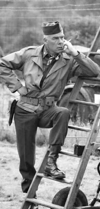 Vintage black and white photo of a soldier on a ladder, deep in thought.