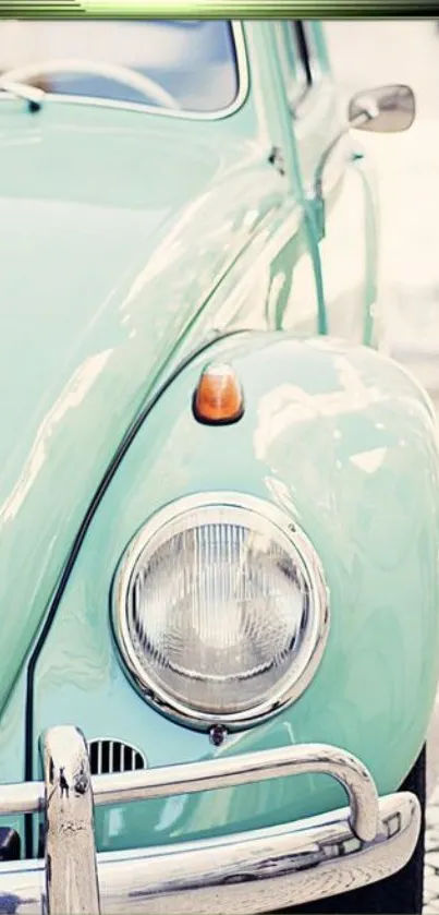 Mint green retro car close-up with sleek vintage design.