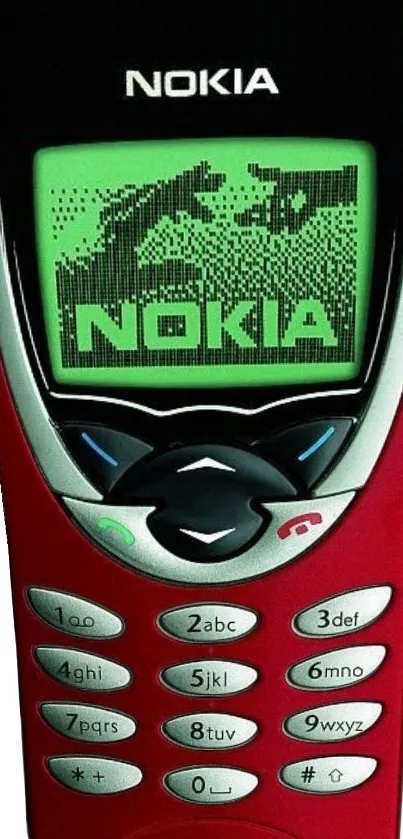 Vintage Nokia mobile phone with green display and red casing.