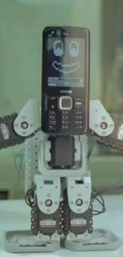 Retro mobile phone robot with smiley face display.