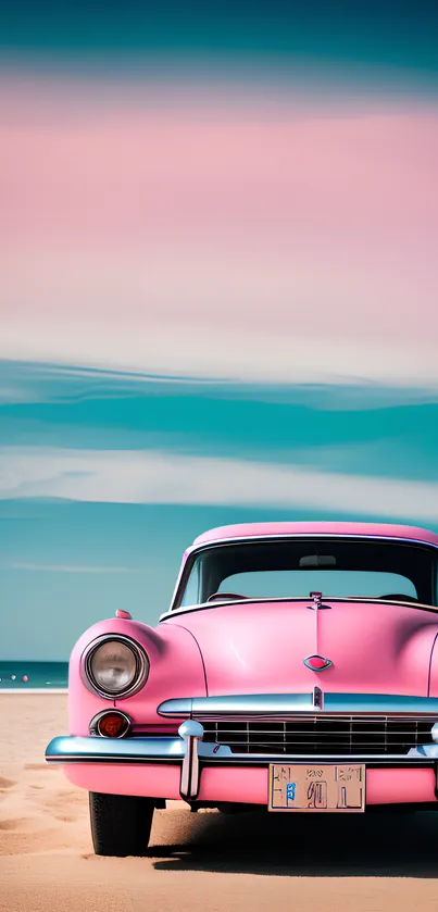 Vintage pink car parked on a sandy beach under a blue sky.