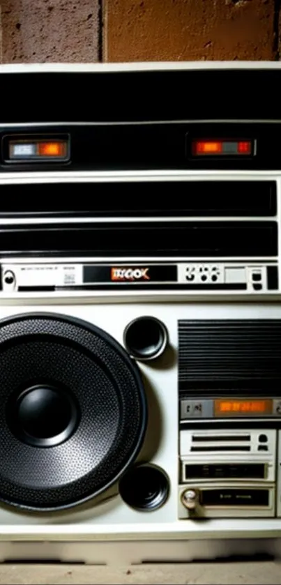 Retro boombox audio system with dials and speakers.